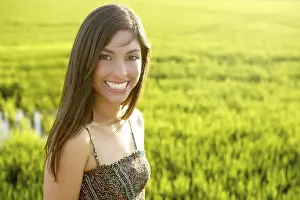 Beautiful brunette indian young woman in the green rice fields meadow