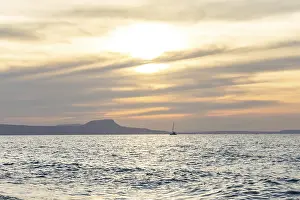 Beautiful coastline with a sandy beach and pebble beach at sunset