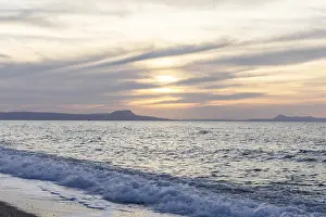 Beautiful coastline with a sandy beach and pebble beach at sunset