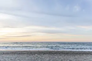 Beautiful coastline with a sandy beach and pebble beach at sunset