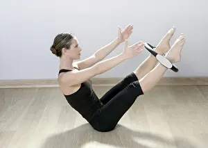 Beautiful instructor woman with magic pilates ring in sport gym