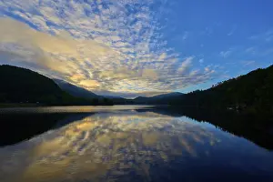 Beautiful lake view with impressive sky and calm water reflecting a peaceful sunrise