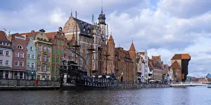 Beautiful old town of Gdansk over Motlawa river Vintage ship pirate caravels sailing on Motlawa river with historic