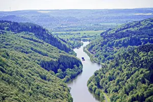Beautiful river flows through green valley surrounded by lush trees