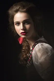Beautiful Russian girl in national dress with a braid hairstyle and red lips