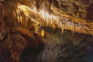 Beautiful stalactites reflecting on the martel lake in the caves of drach