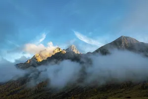 Beautiful sunny mountain top above the clouds between Falcade and the Valles pass