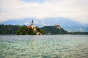 Beautiful view on lake Bled against of mountains in clouds