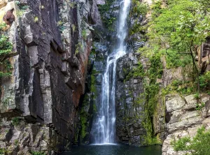 Beautiful waterfall of Veu da Noiva between the covered stones of moss