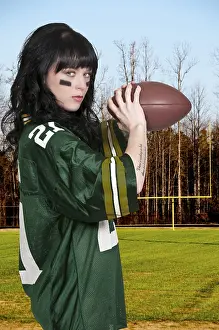 Beautiful young woman playing a game of football