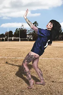 Beautiful young woman playing a game of football