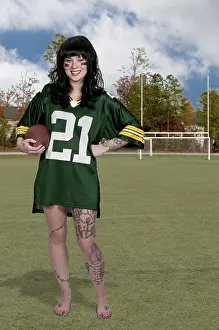 Beautiful young woman playing a game of football