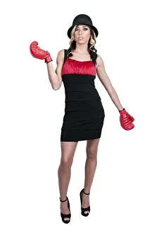 A beautiful young woman wearing a pair of boxing gloves