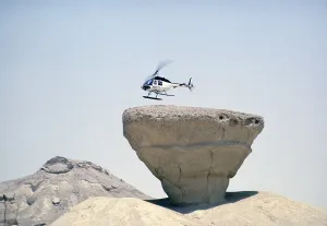 Bell 206 JetRanger helicopter landing on a rocky outcrop Arabian Desert, Saudi Arabia Oil industry 1979