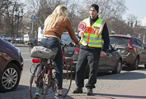 A Berlin police officer stops a cyclist during a traffic stop