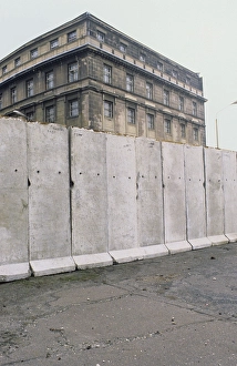 The Berlin Wall. A guarded concrete barrier that encircled West Berlin from 1961 to 1989