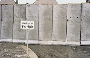 The Berlin Wall. A guarded concrete barrier that encircled West Berlin from 1961 to 1989