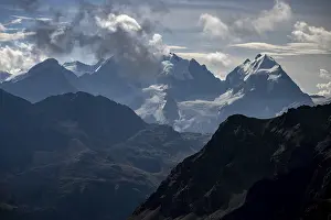 Bernina Group with Engadine Mountains with Cloudy Sky