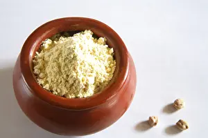 Besan gram flour in clay pot, India