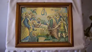 Biblical icon in a wooden frame shows a religious scene with disciples and saints