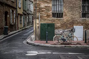 Bicycle parks next to a road surface marking for bicycle lane on a street