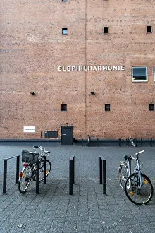 Framed Print : Bicycles parked in front of the brick facade of the Elbphilharmonie in Hamburg Framed Print : Bicycles parked in front of the brick facade of the Elbphilharmonie in Hamburg