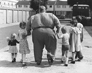Big man with children, England, Great Britain