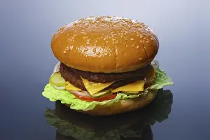 Big tasty burger with reflection on glossy surface