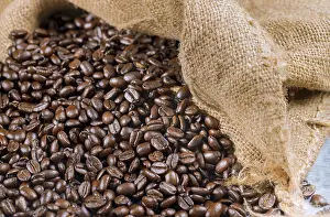 Black coffee beans in a bagging. Close up