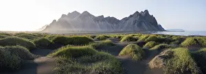 Black lava beach, sandy beach, dunes with dry grass