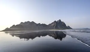 Black lava beach, sandy beach and sea