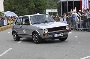 A black and red Volkswagen GTI classic car at a rally