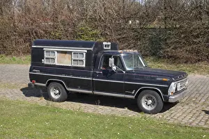 Black vintage Ford F100 Styleside Sport custom pickup truck with camping body