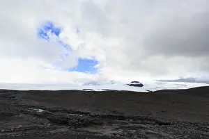 Black volcanic landscape with remnants of snow