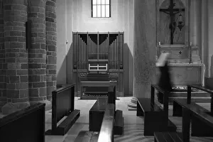 A black and white photo of a church interior with an organ