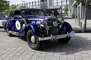 Blue classic car with elegant design during an outdoor event