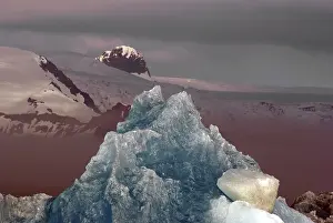 Blue ice, mountains rising out of the mist