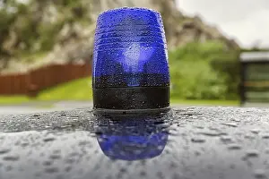 Blue light on a car roof, police patrol car
