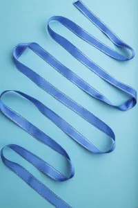 Blue ribbon on a blue pastel background