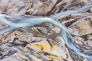 Blue river arms flowing through lava sand