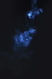 Blue smoke against black background