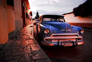 Blue vintage car at night in San Cristobal de las Casas