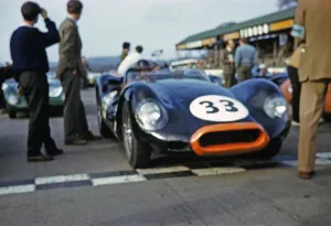Blurred photo of British sports racing driver Bill de Selincourt (1921 2014) at the wheel of the Lister Jaguar Knobbly Auto 33, BARC Goodwood event, March 1961 on the start line