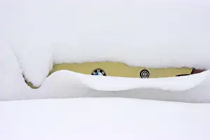 A BMW oldtimer completely covered in snow
