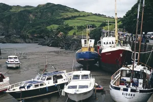 Boats in the harbour at low tide, Ilfracombe, North Devon, England, UK 1970s yacht Kiboko, registered in Yarmouth