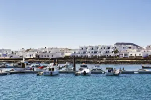 Boats in the harbour, white houses