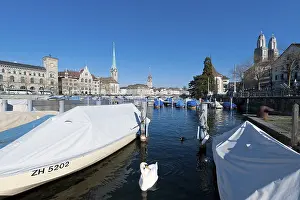 Boats on the Limmat River, historic district of Zurich with Johanneskirche church