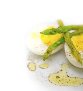Boiled fresh green asparagus and eggs with extra virgin olive oil