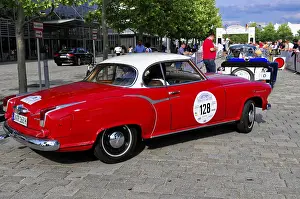 Borgward Isabella Coupe, A red vintage car drives along the road at a car event