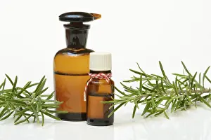 Bottled rosemary oil and rosemary sprig